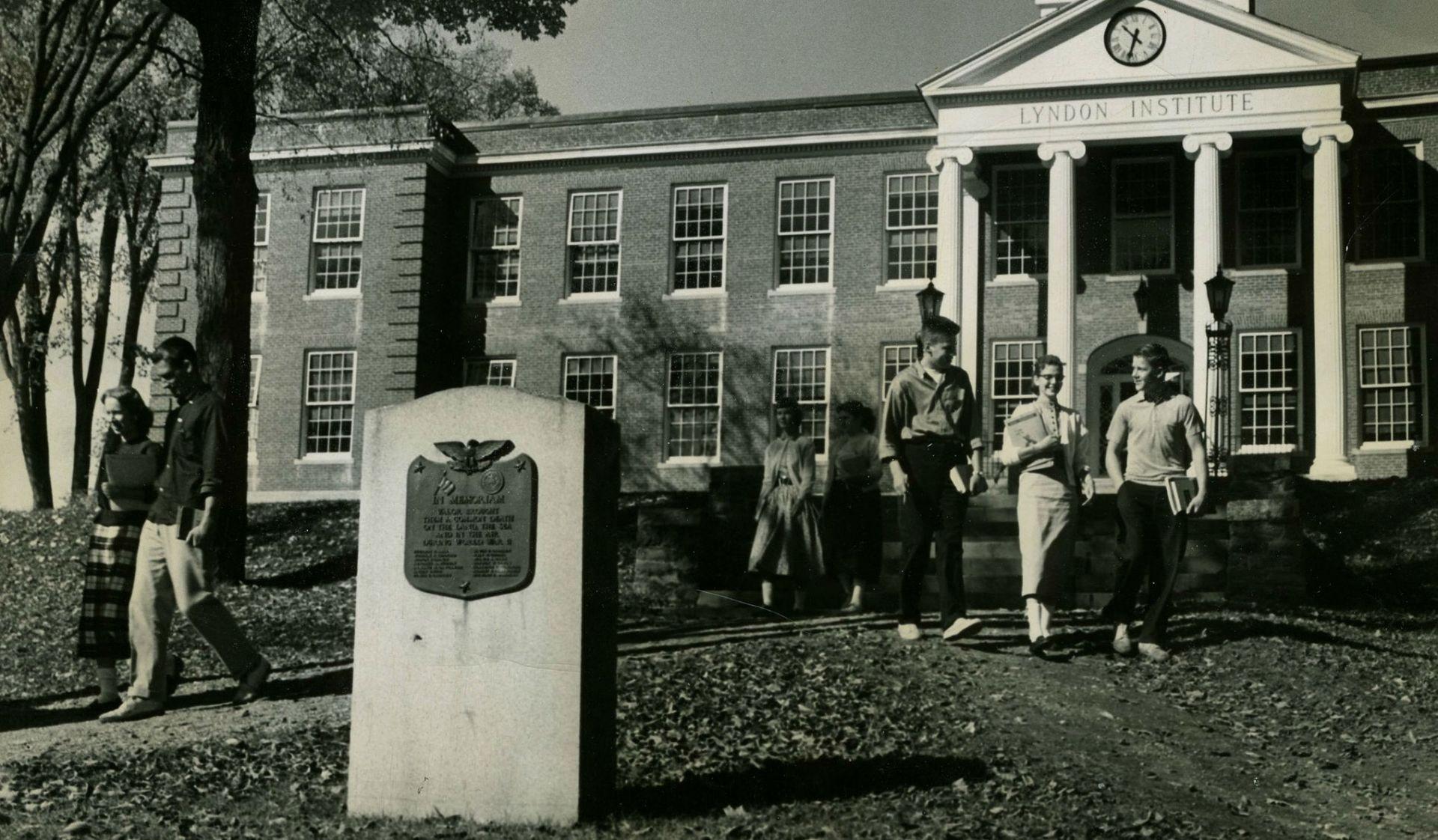 Historic photo of students walking in front of the Main Building. 