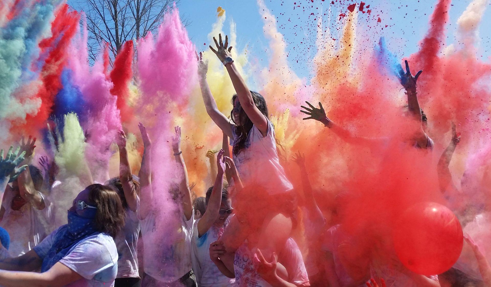 Photo of people throwing color at a color run. 