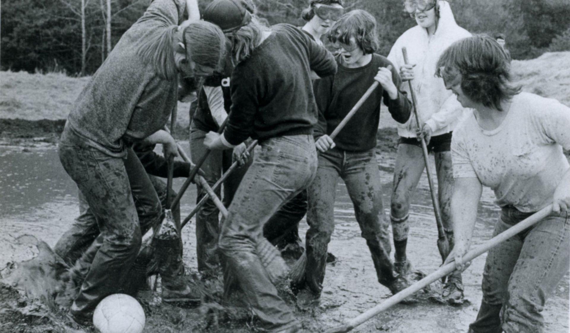 Historic photo of students playing broom ball. 