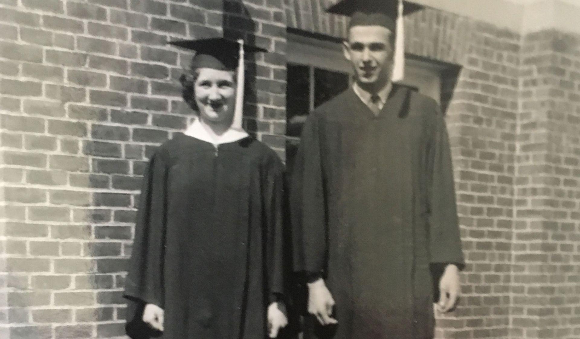 Historic photo of a pair of graduates. 